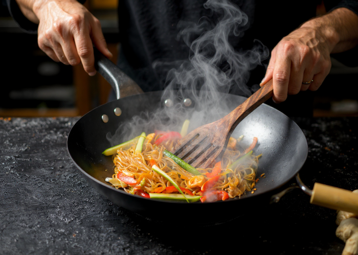 asian wok stir fry flames vegetables noodles in wok pan